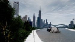 A pedestrian walk by the river with the city as background